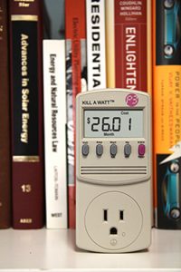 Kill-a-watt monitor in front of library books