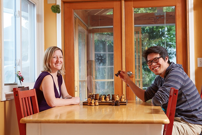 The Suzuki family playing chess in their energy-efficient home