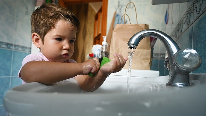 a young child at a bathroom sink