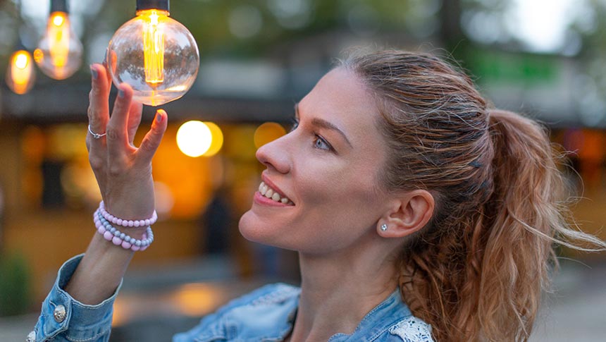 woman looking at lightbulb