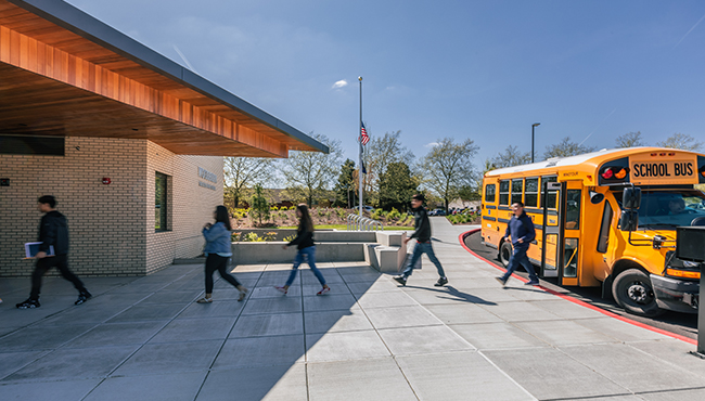 Children going into school from bus