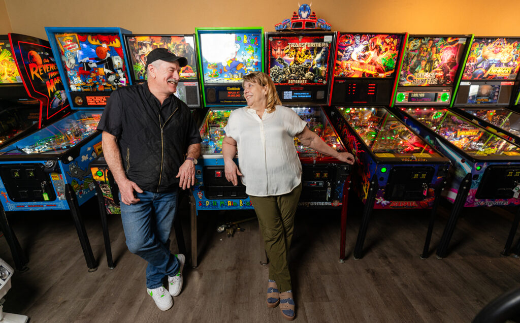 Arcade owners in front of arcade games