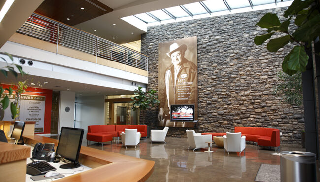 Inside a building lobby with chairs and tables