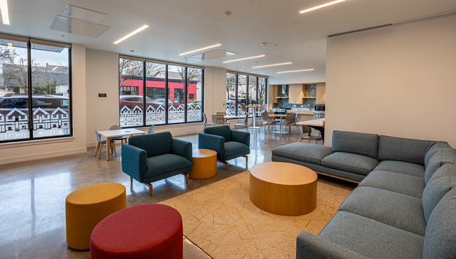 Lobby with colorful furniture, concrete floors and large windows