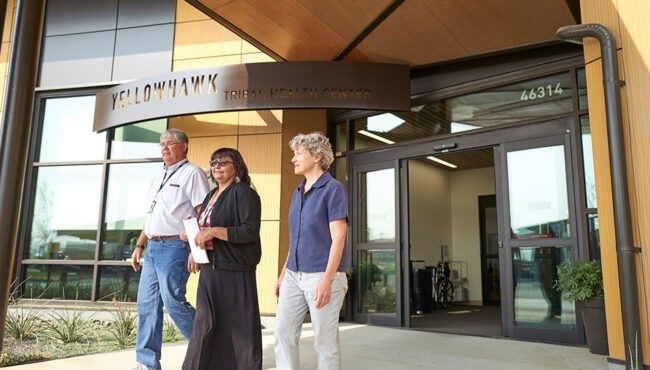 Man and women walk in front of Yellowhawk Tribal Health Center