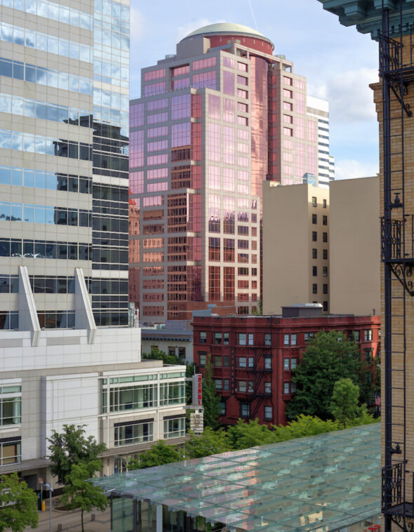 a large pink building in a city