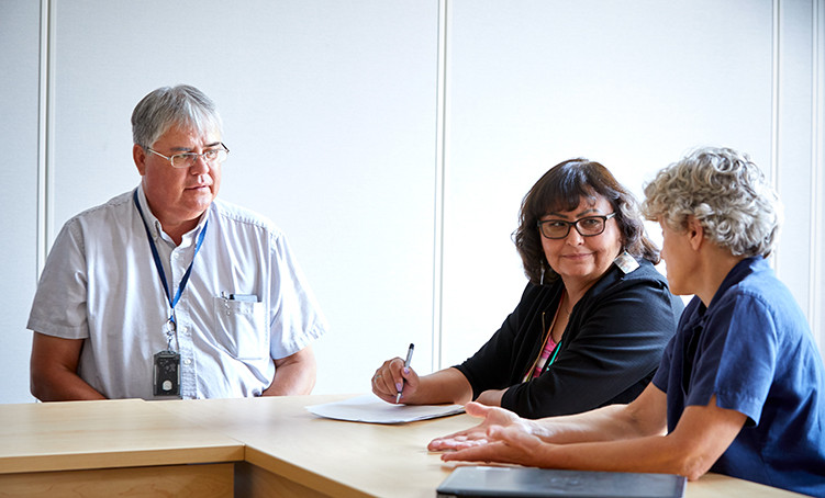 Three people at a table meeting