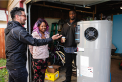 people looking at a new water heater in their garage